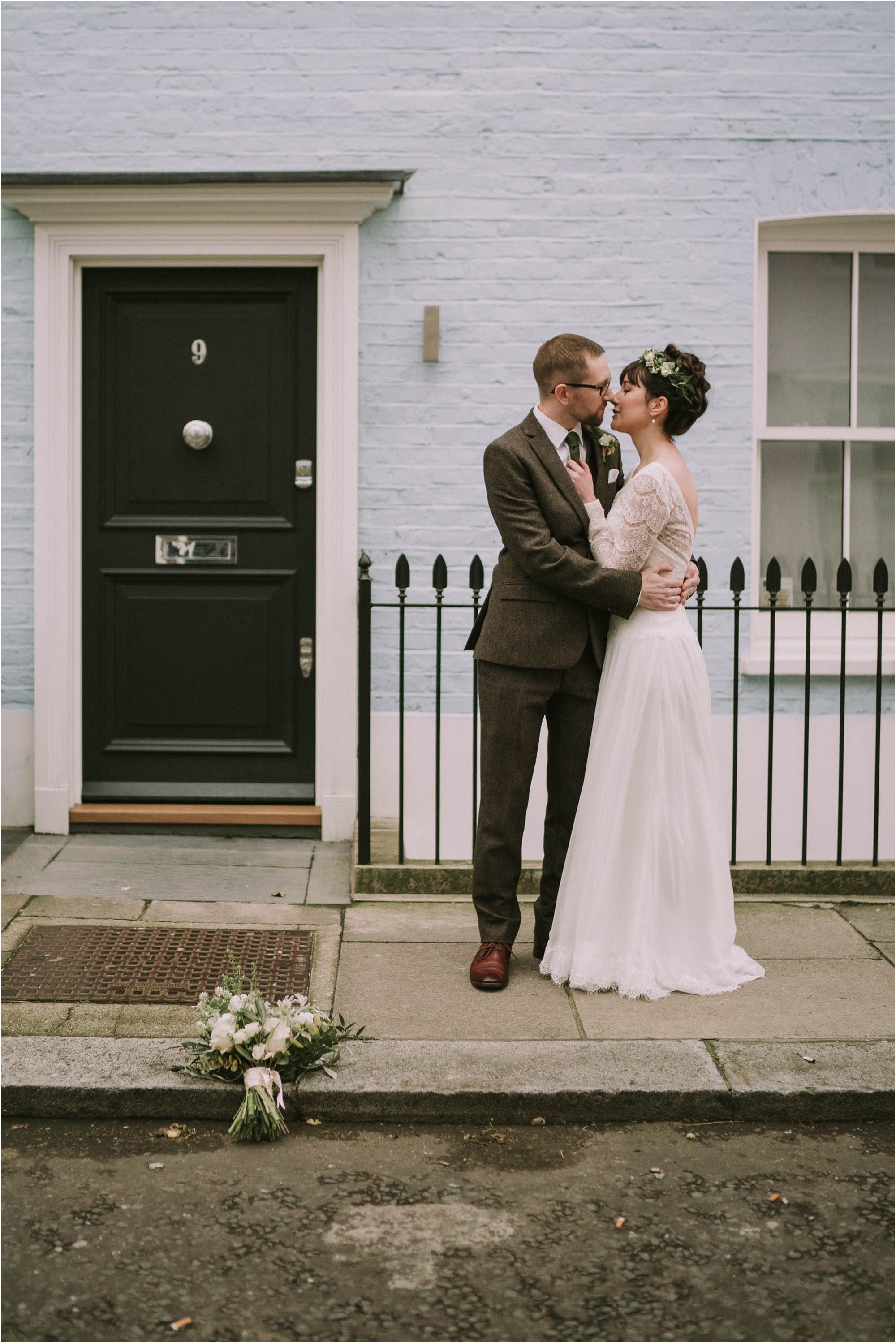 Bride and Groom against london coloured house