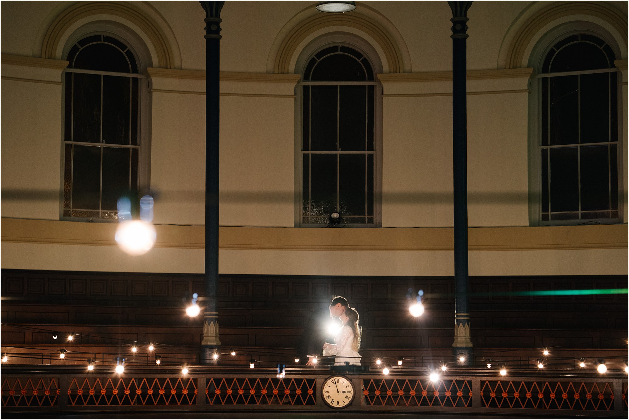 bride and groom kissing on the balcony at the Round Chapel in Hackney, London