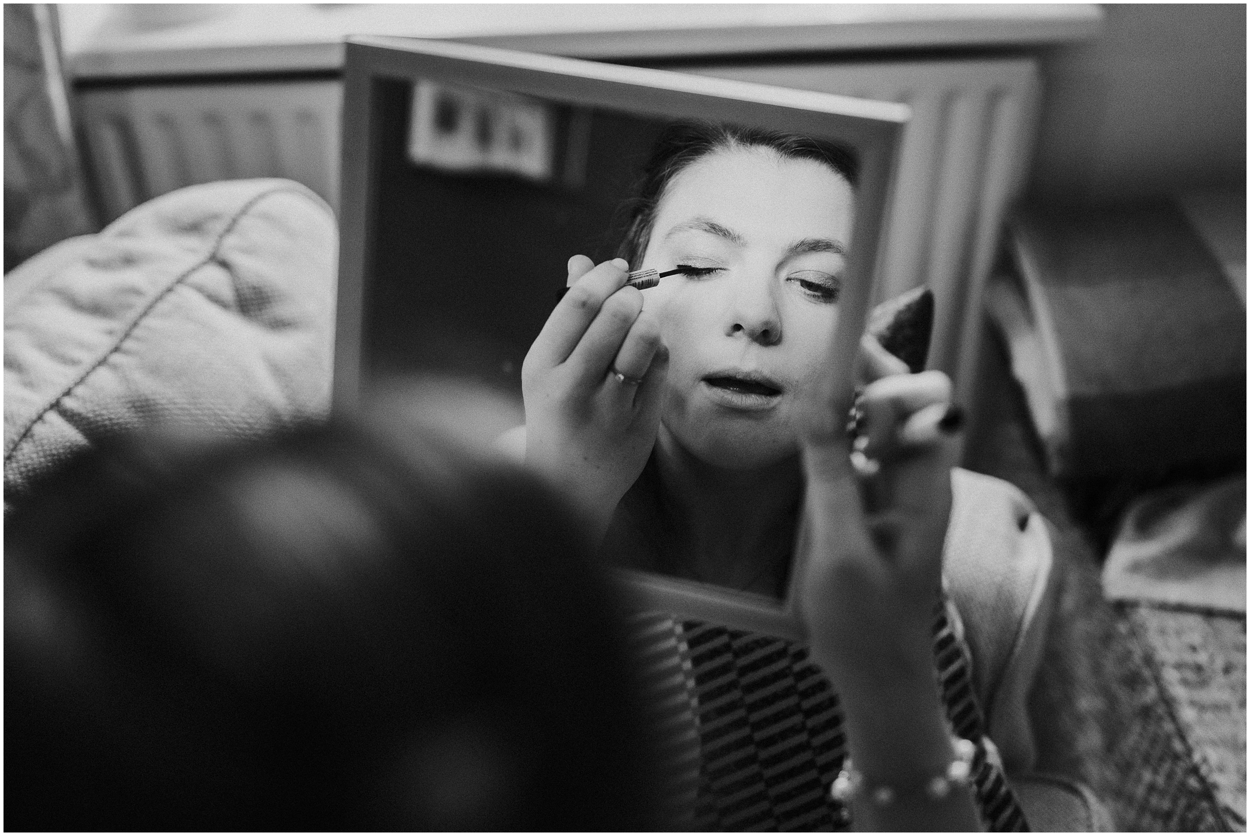 A bride doing her own makeup.