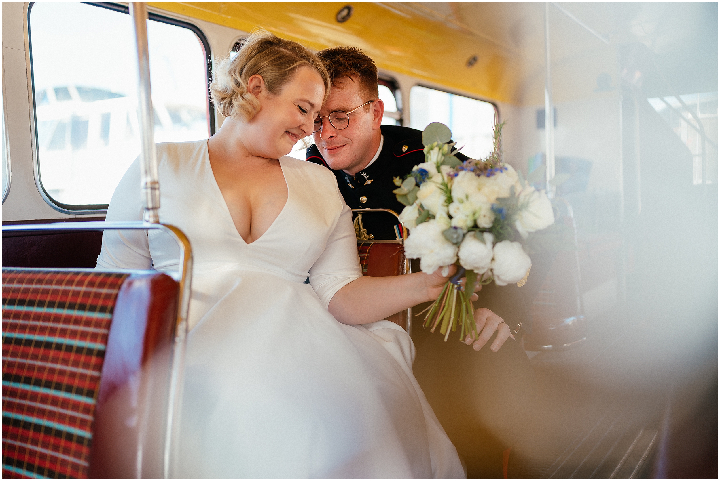Wedding guests riding a vintage red wedding bus. 