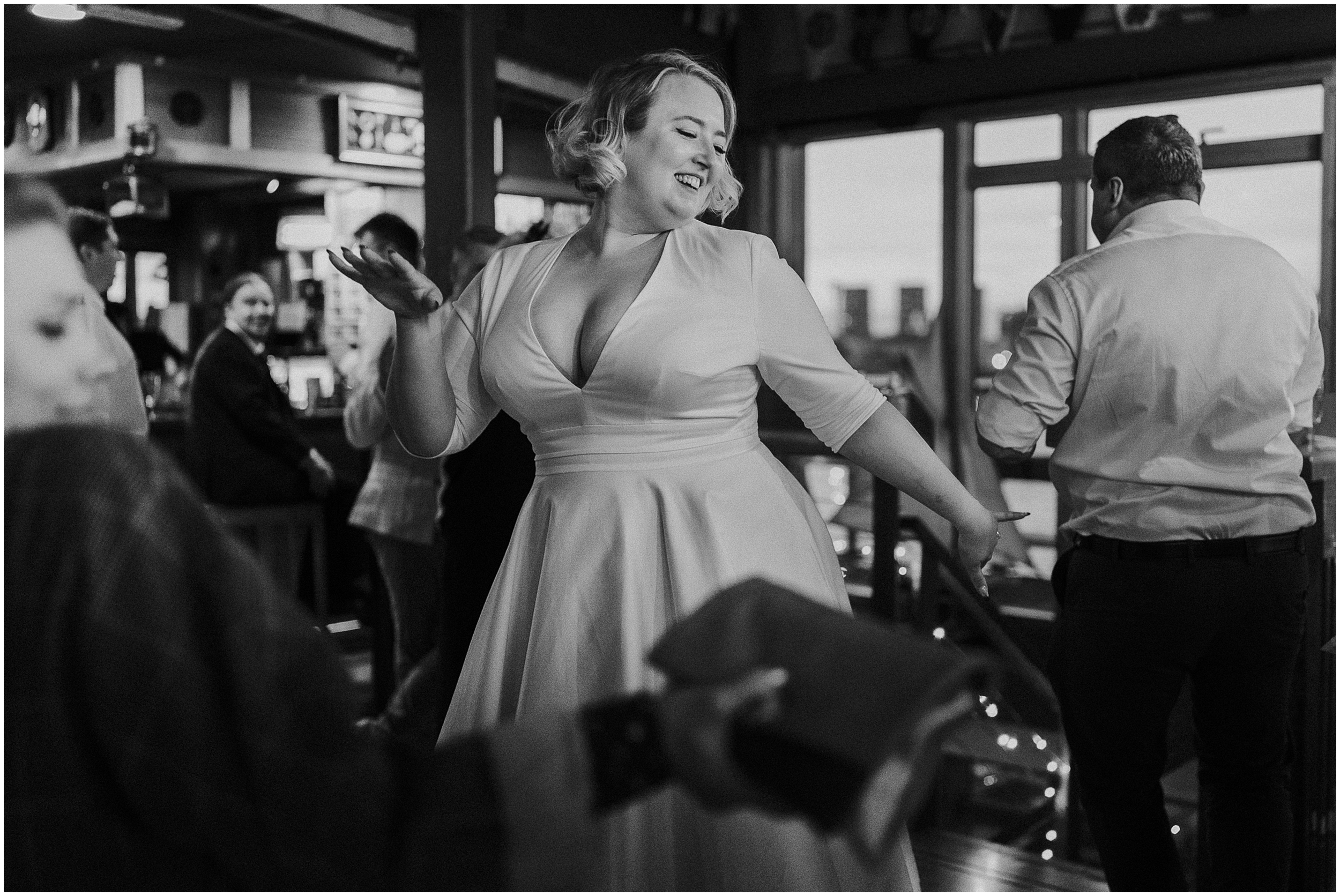 A black and white photo of a bride dancing at the Greenwich Yacht Club. 