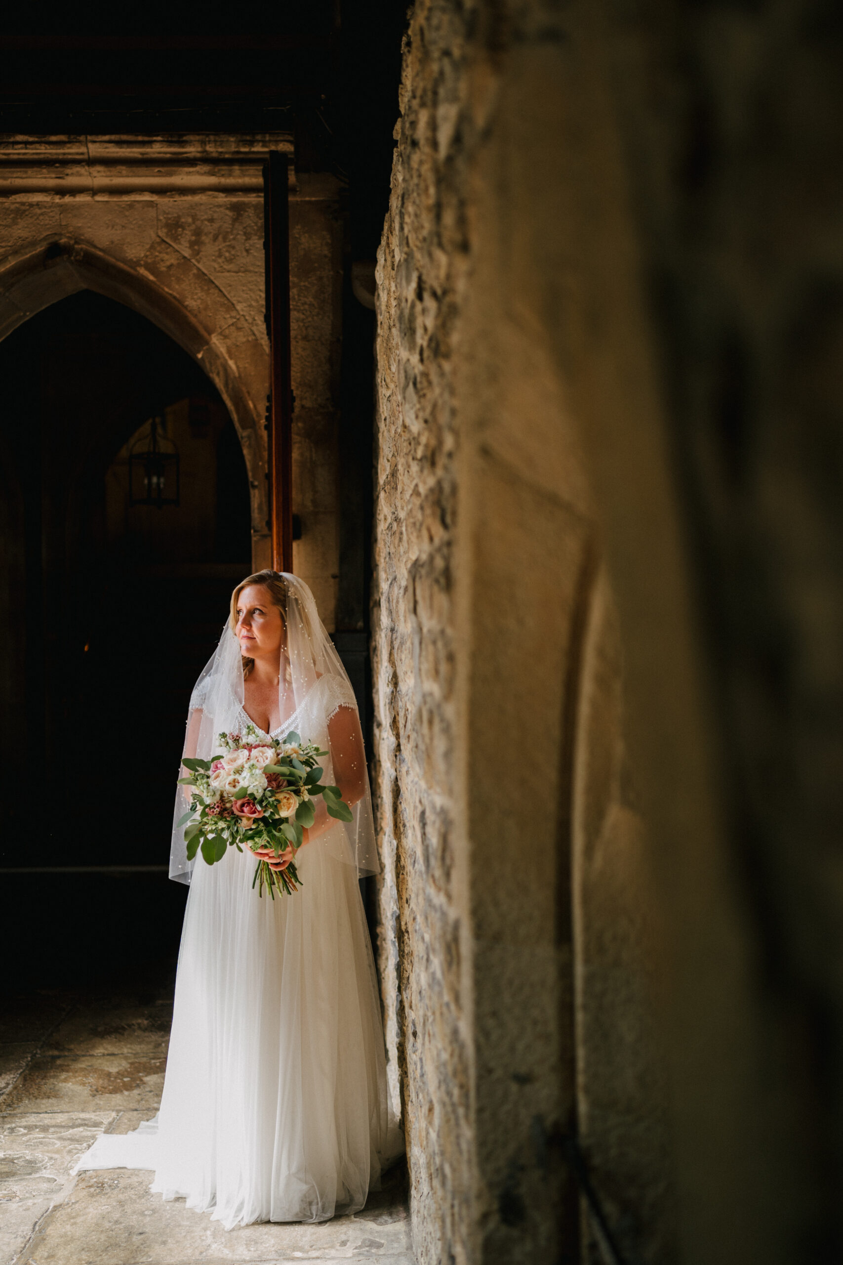 A bride standing inside of St Etheldreda's Church in London. 