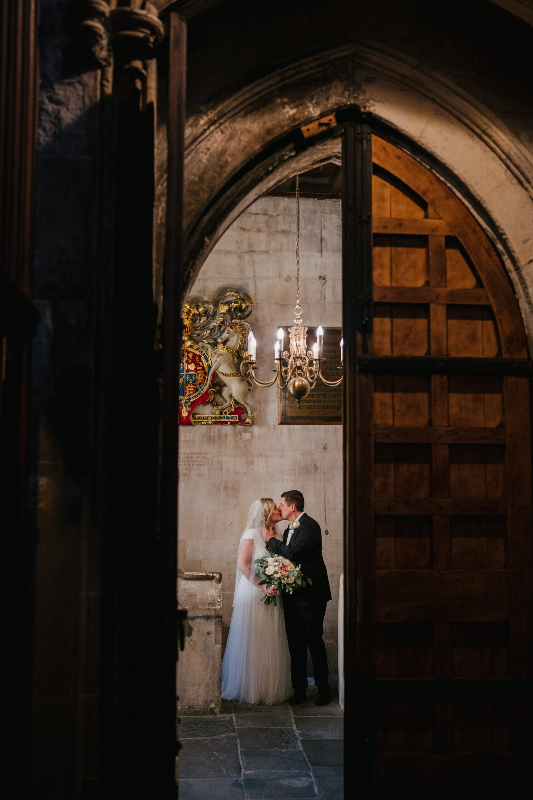 A bride and groom share a kiss in St Etheldreda's Church in London. 
