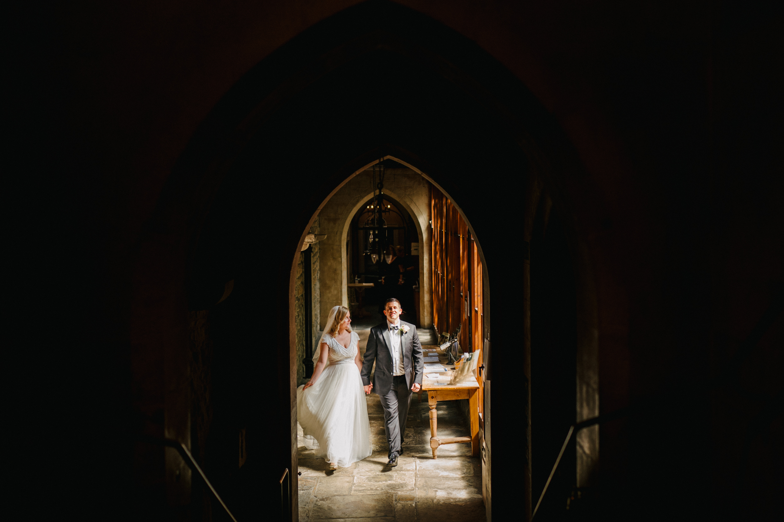 A wedding couple walking towards their wedding in St Etheldreda's Church in London. 