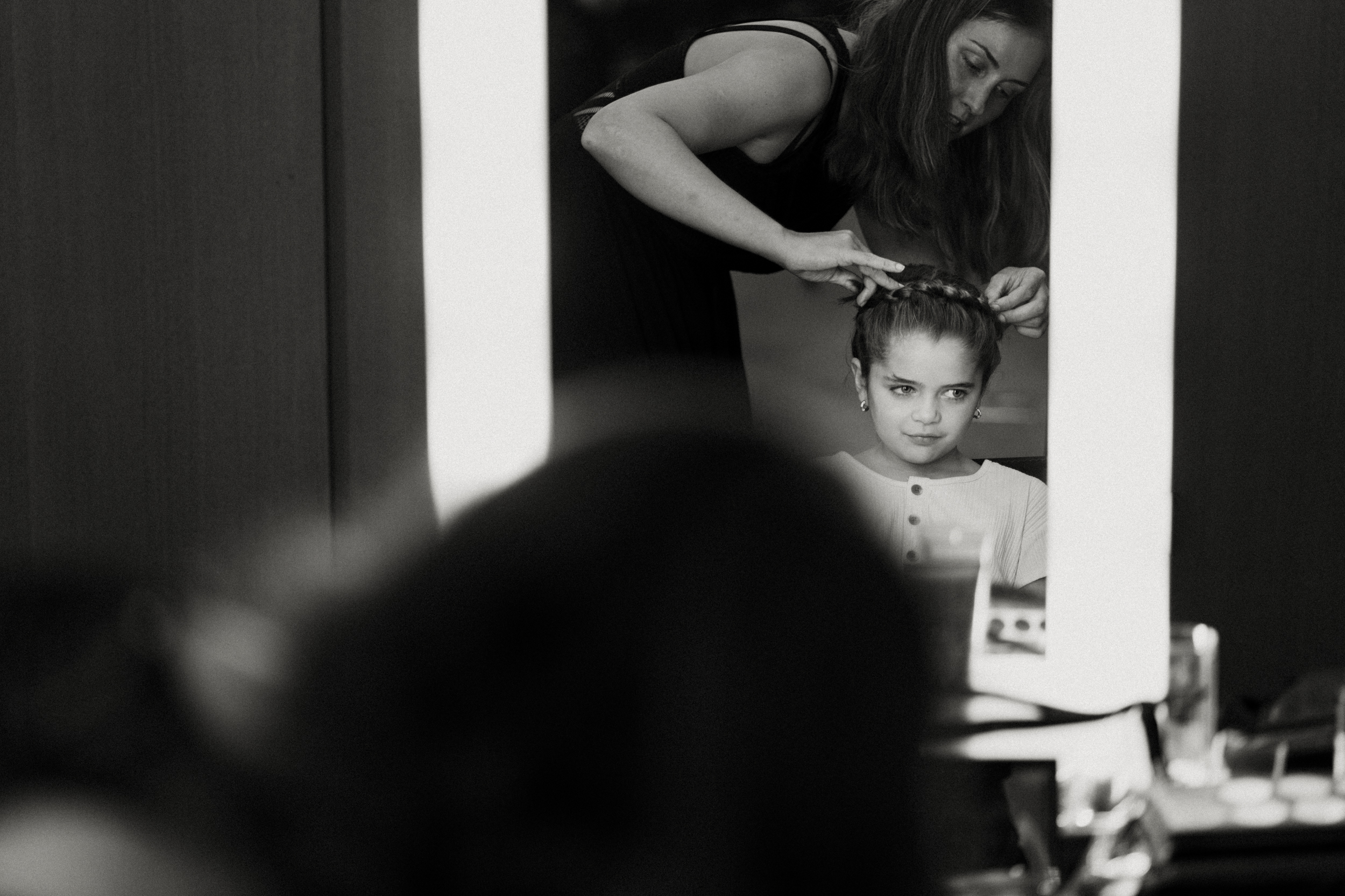 A flower girl having her hair done at the Hotel Cafe Royal in London. 