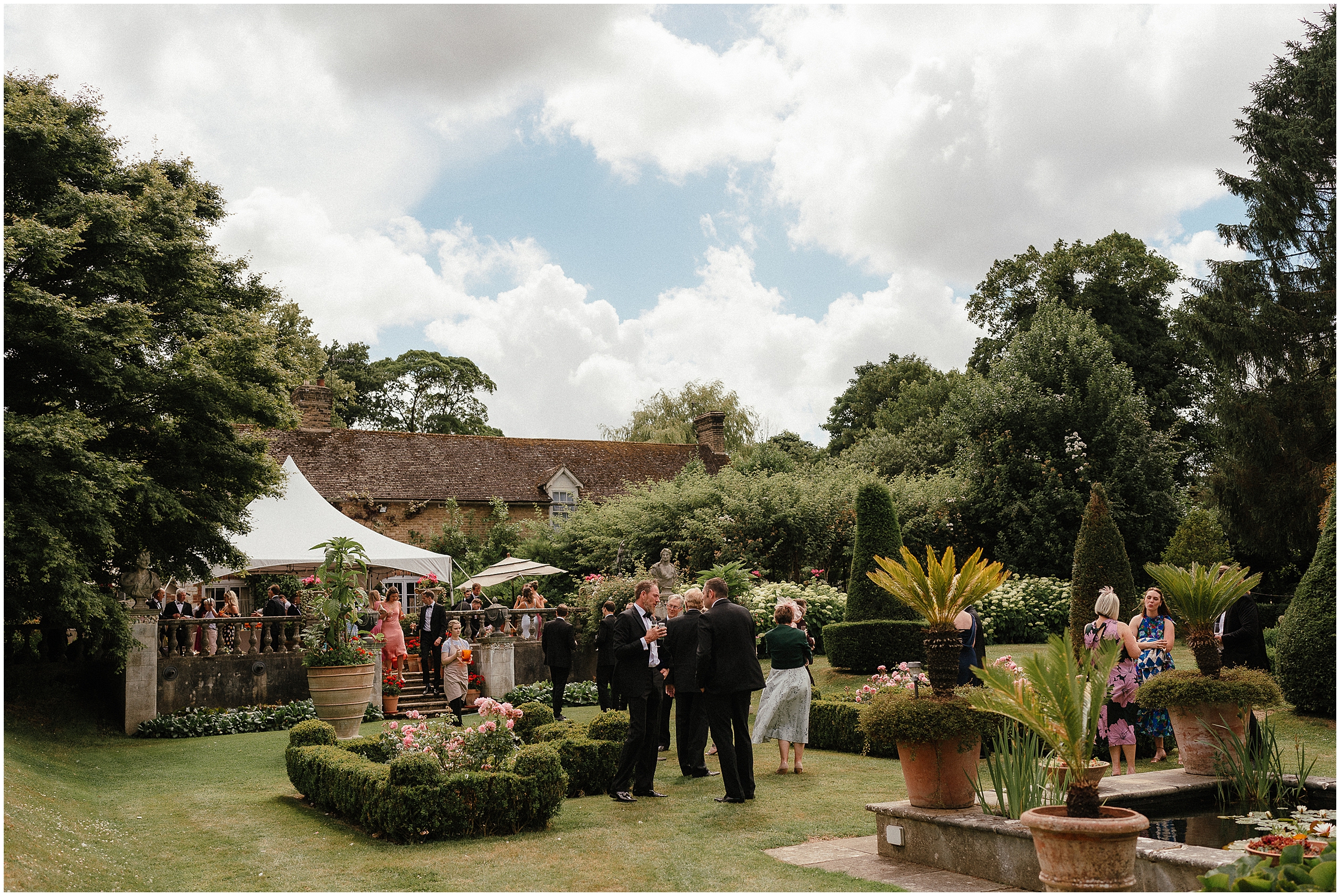 Wedding guests in the gardens of the old rectory estate. 