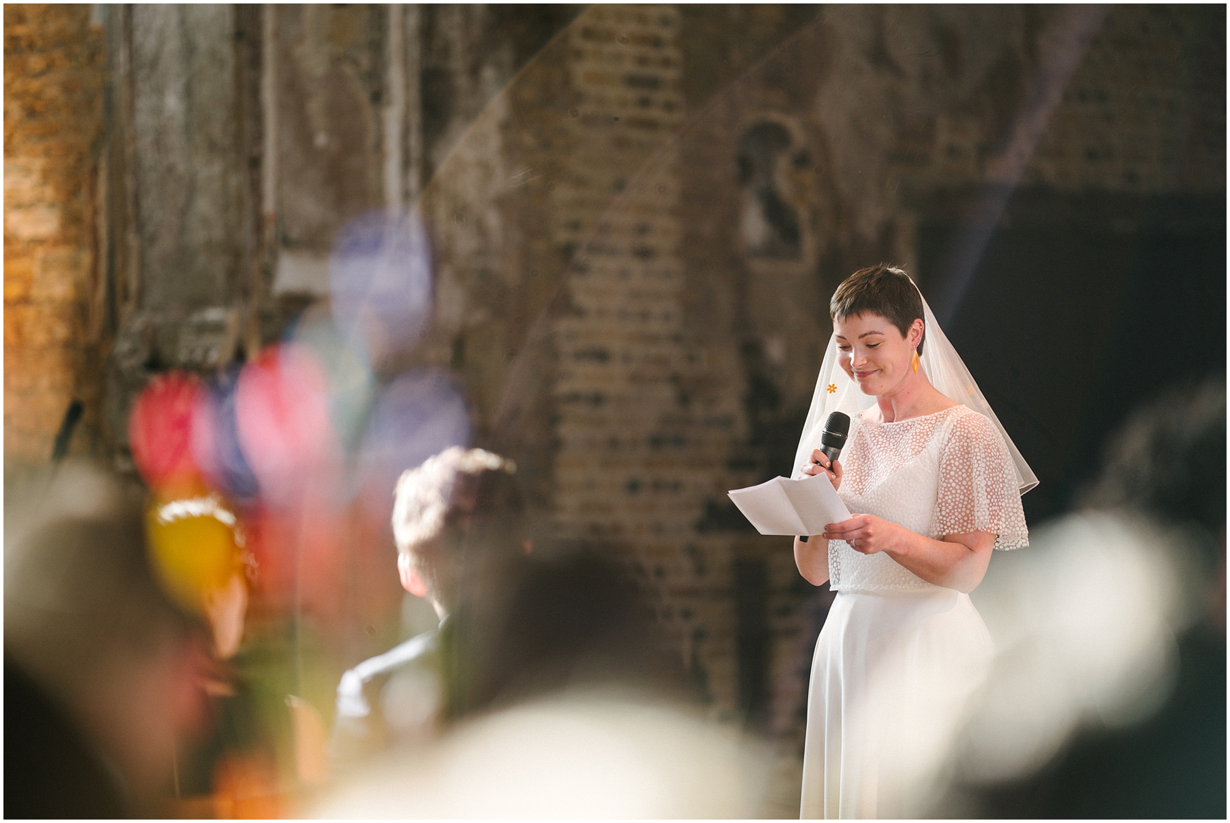 A bride giving a speech during her wedding at the Battersea Arts Centre. 
