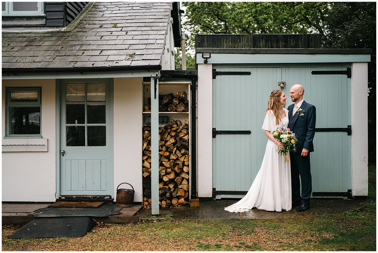 A couple during their rainy wedding at Tournerbury Woods, Hayling Island. Photographed by Kari Bellamy. 