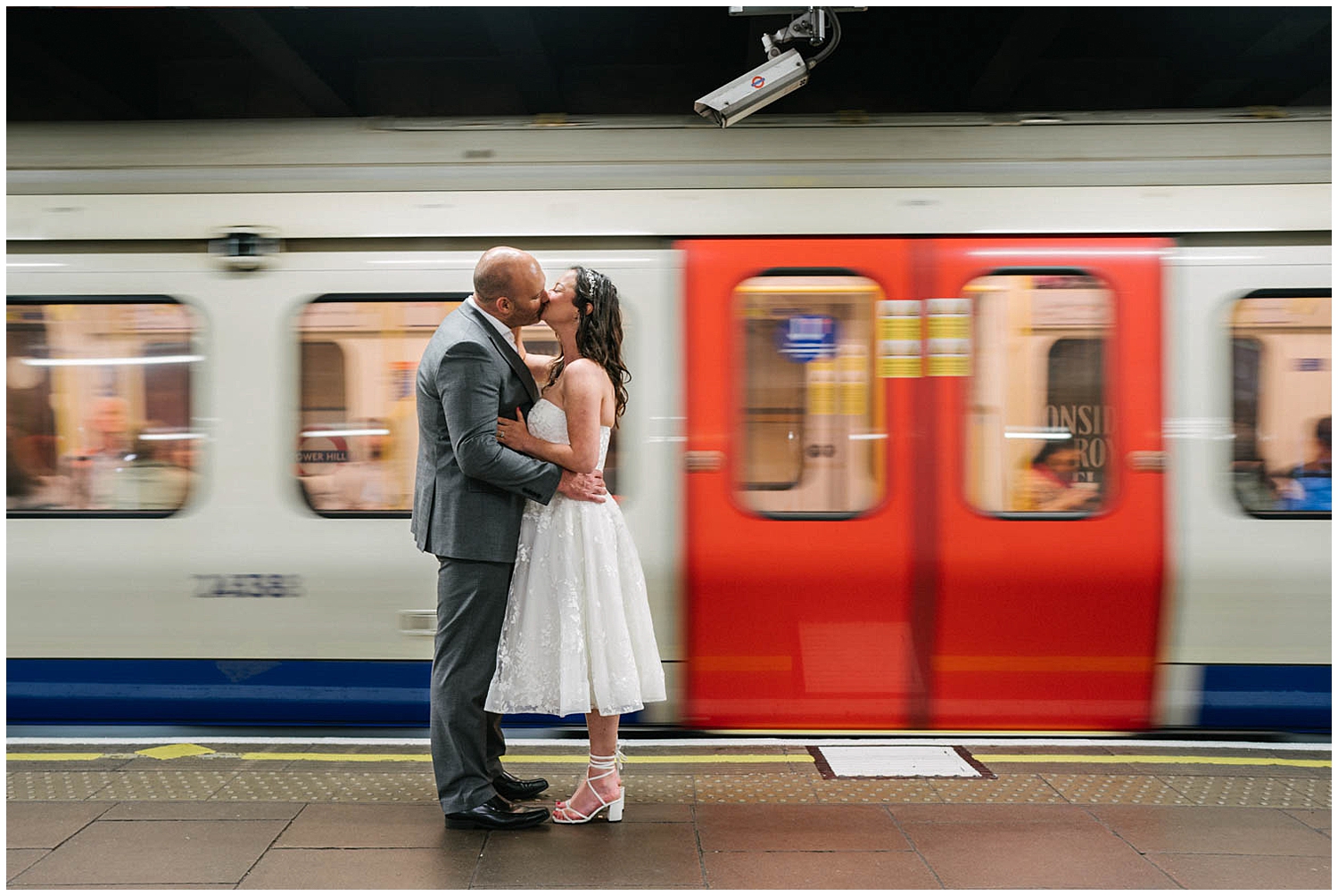 A couple kissing on the London Underground. Photographed by Kari Bellamy. 