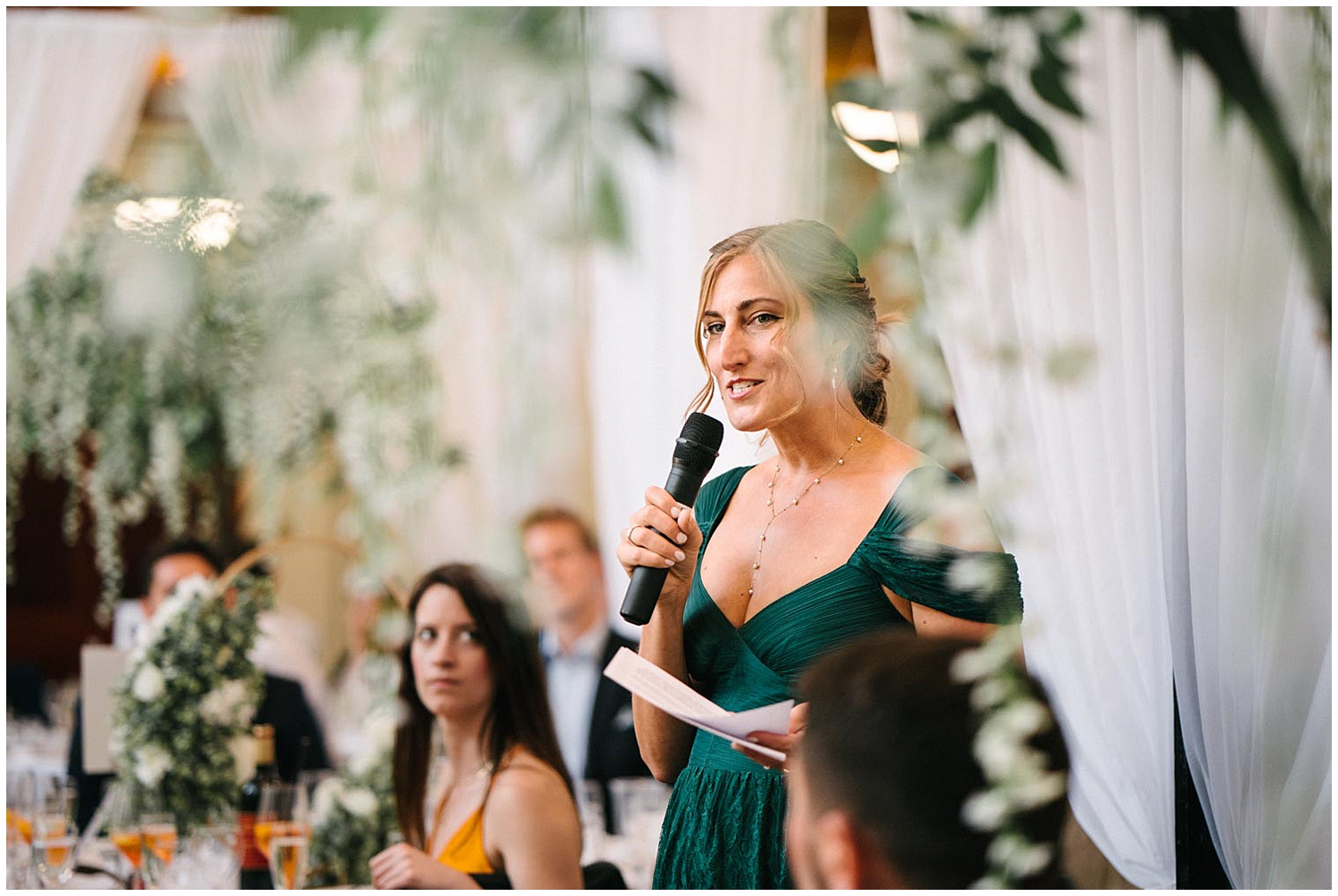 A bridesmaid giving a speech during a wedding reception. 
