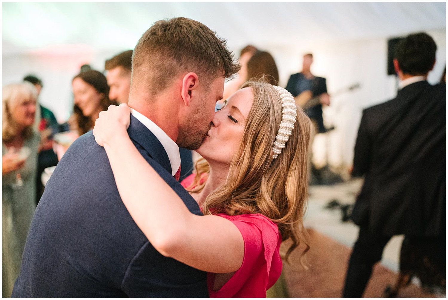 A candid shot of wedding guests kissing during the dancing. Photographed by South Yorkshire wedding photographer Kari Bellamy. 