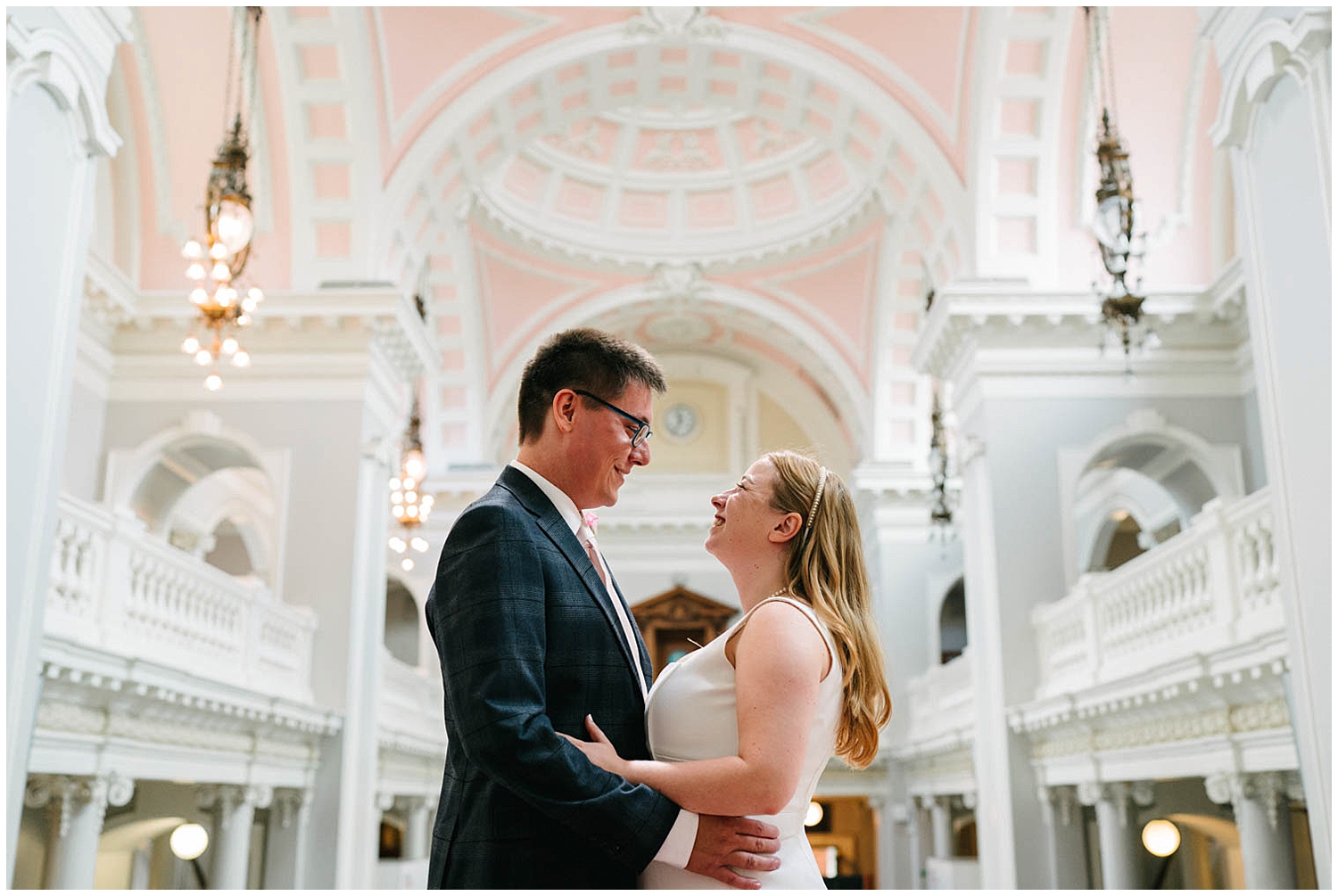A couple inside of Woolwich Town Hall in South East London. Photographed by Kari Bellamy. 