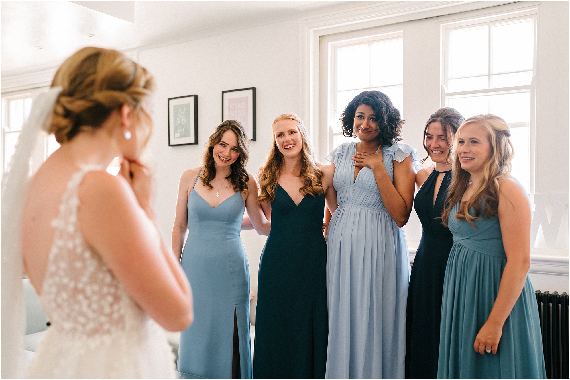 Bridesmaids seeing a bride for the first time in her dress. 