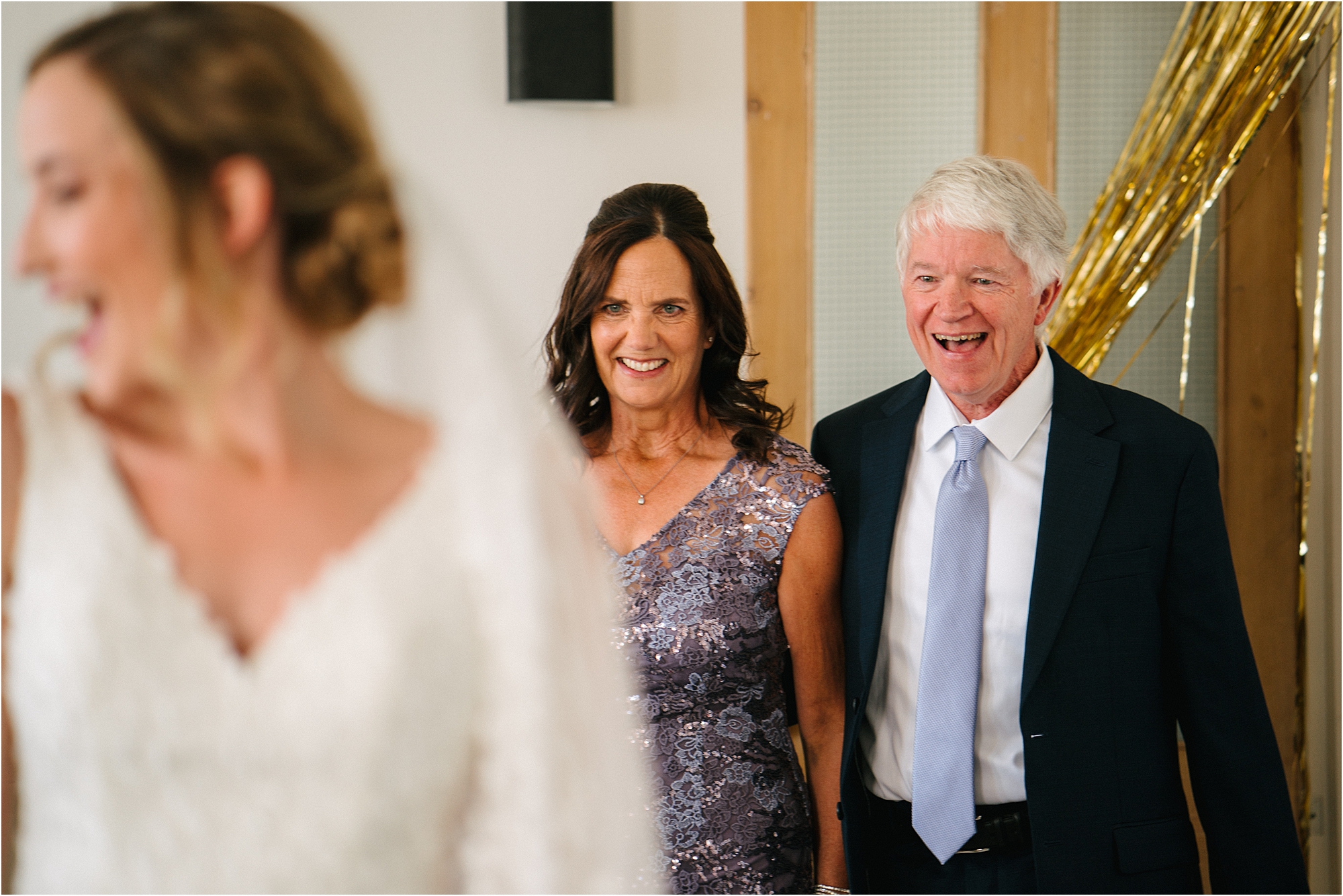 Parents admiring a brides dress. 