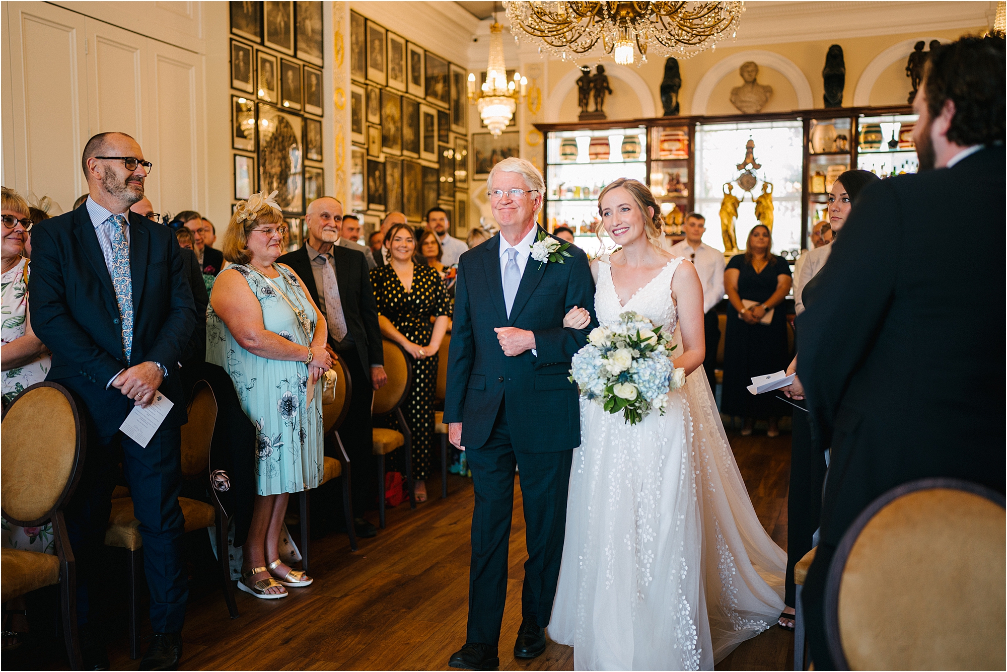 A bride walking down the aisle with her father at the Trafalgar Tavern Greenwich, London.