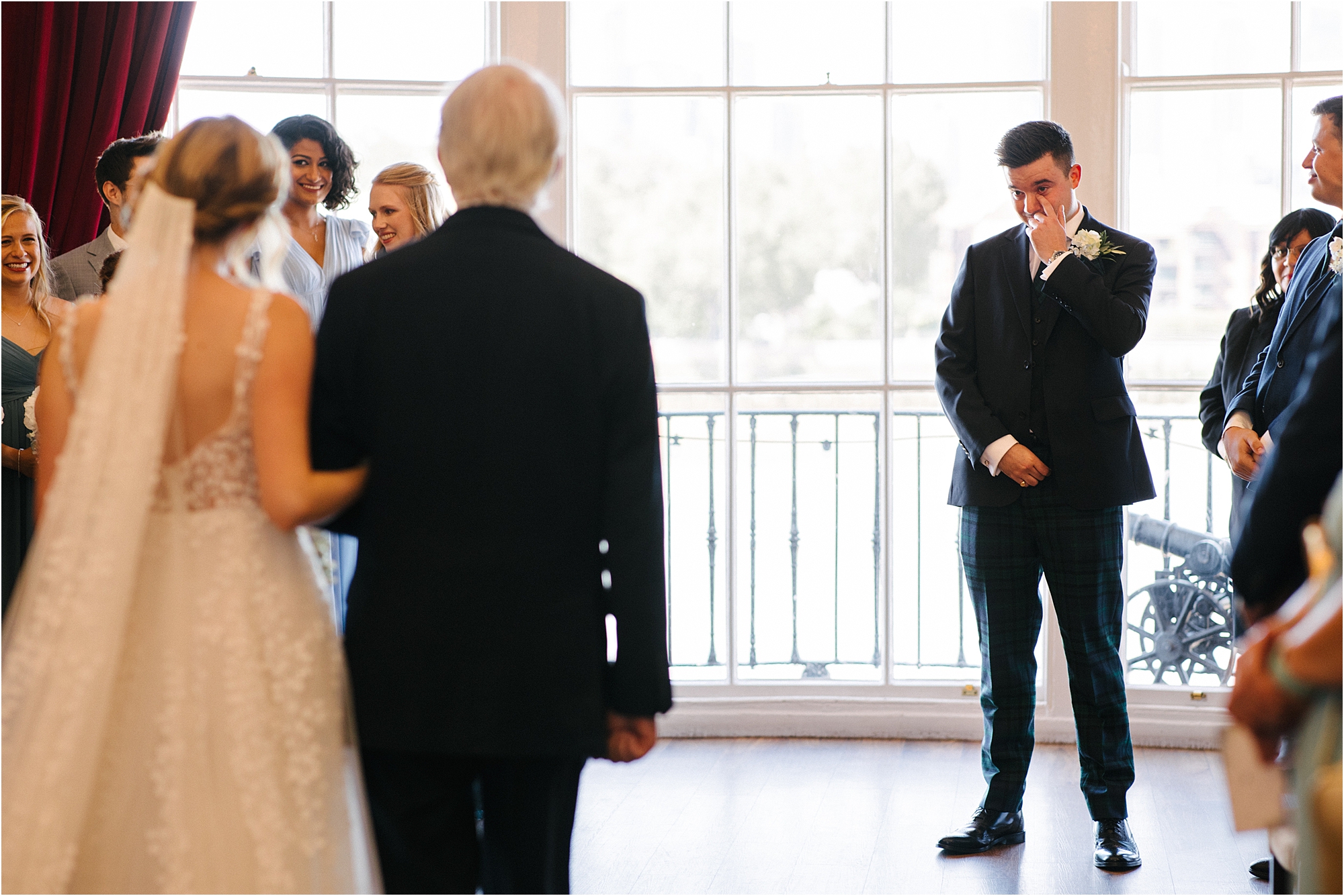 A groom reacting to his bride walking down the aisle at the Trafalgar Tavern Greenwich, London.