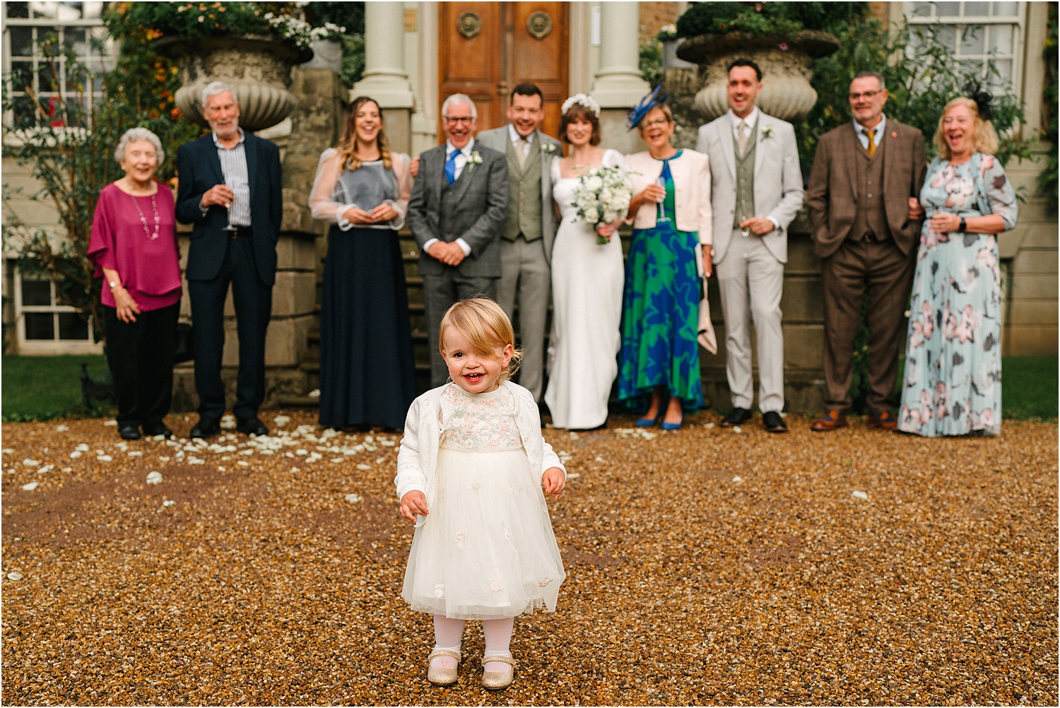 A family group shot at a wedding outside of Hampton Court House. 