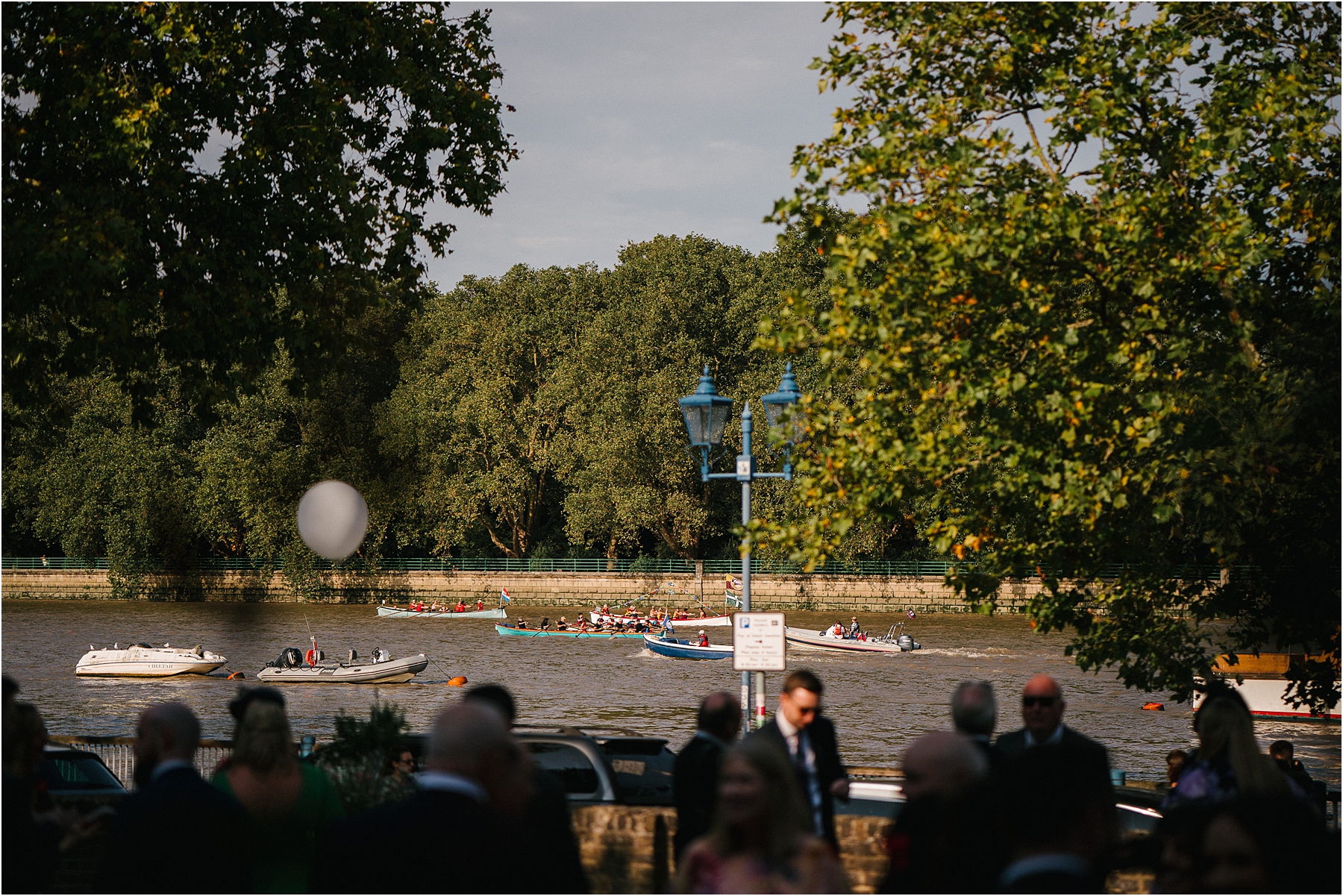 Watching the boats along the river thames during a wedding reception at Winchester House in London. 