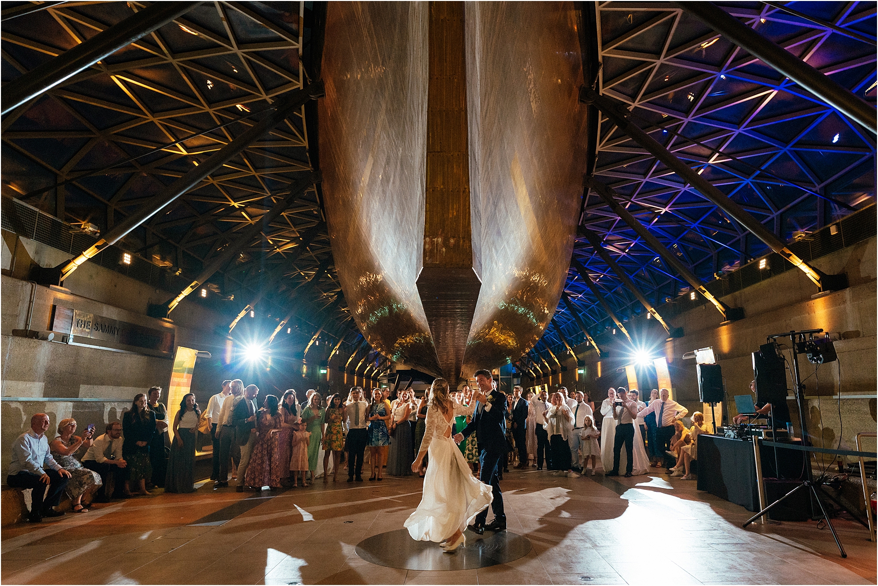 A bride and grooms first dance underneath the Cutty Sark.