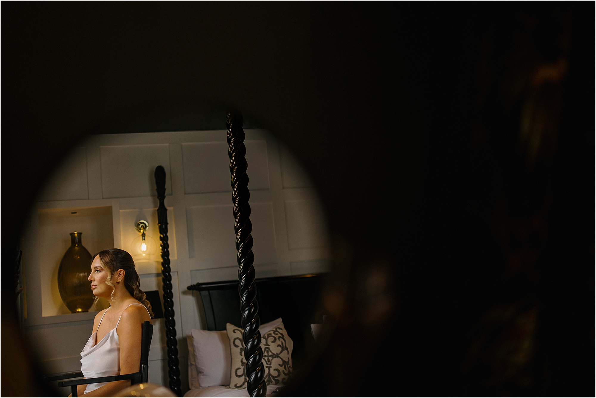 A colour photograph of a bride in the makeup chair getting ready for her wedding at The Manor House Lindley. 