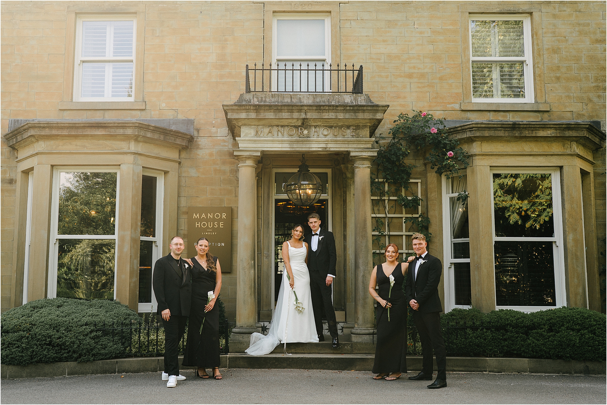 The wedding party outside of the Manor House Lindley. 
