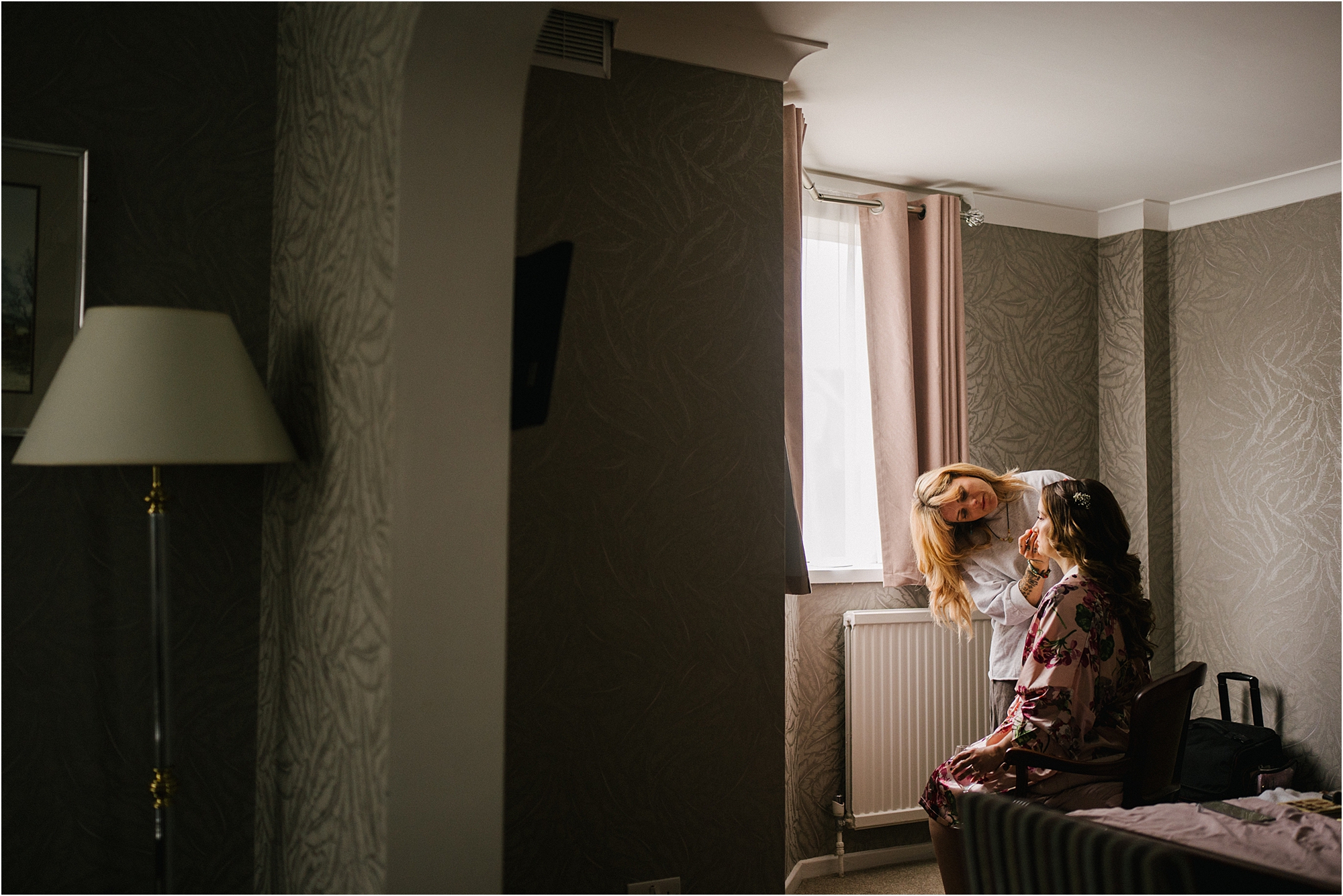 A bride having her makeup done before her wedding at The Claredon Hotel in Blackheath, London. 