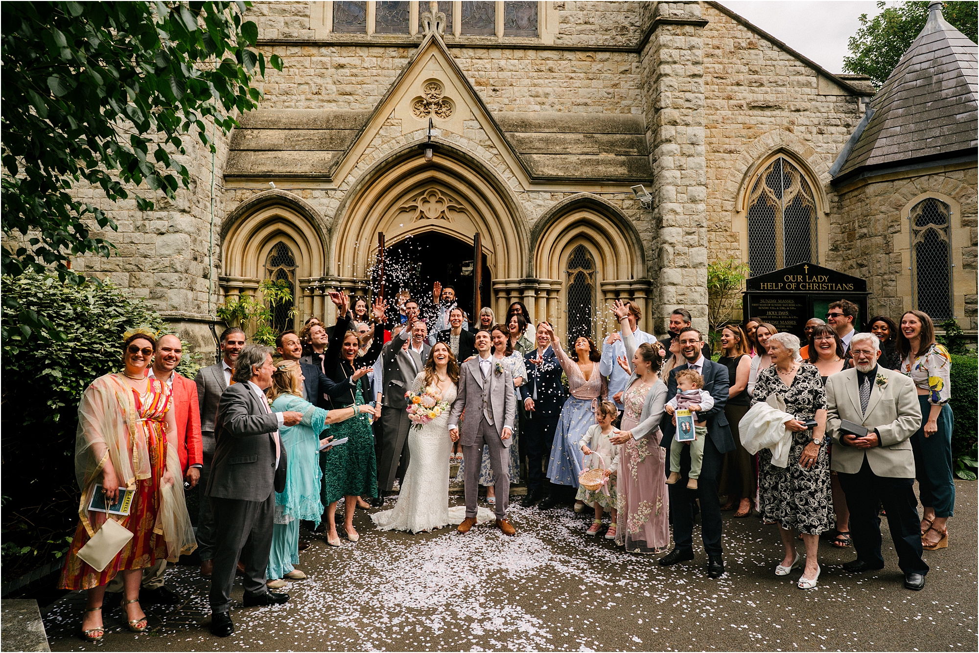A group shot of a wedding at Our Lady, Help of Christians Catholic Church Blackheath, London. 