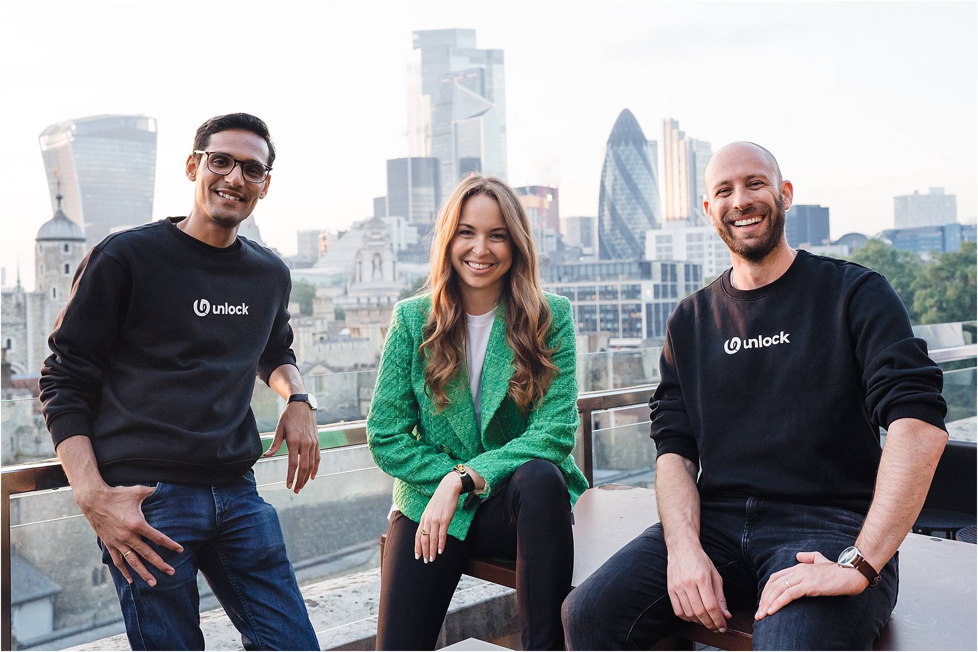 A relaxed portrait of a startup leadership with a view over central London. 