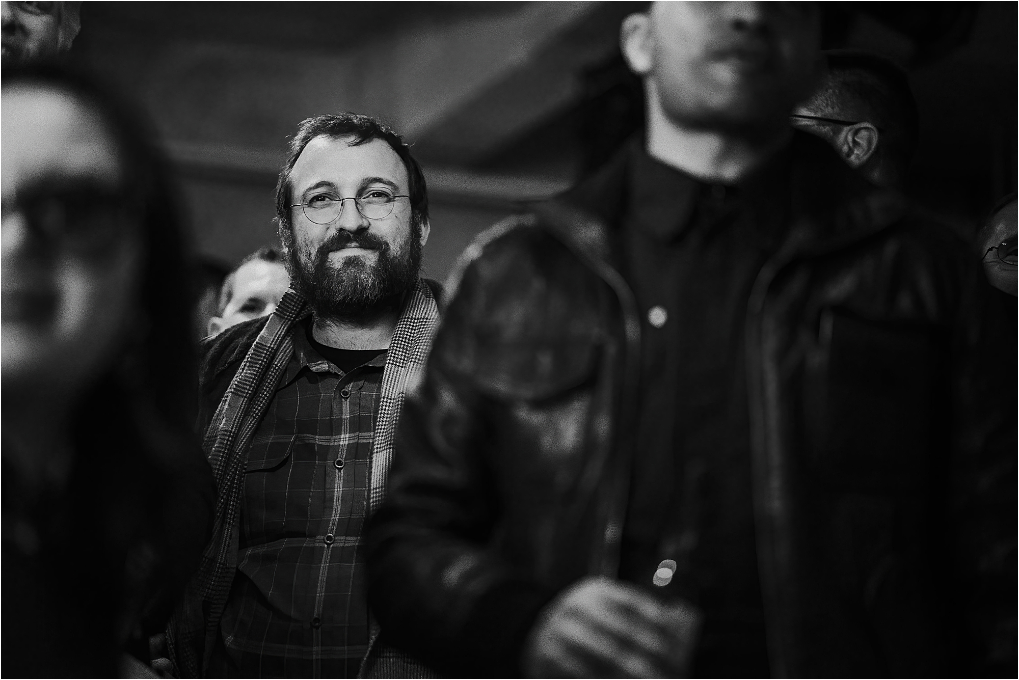 A black and white photo of crypto founder Charles Hoskinson at a launch event. Photograph by Kari Bellamy. 