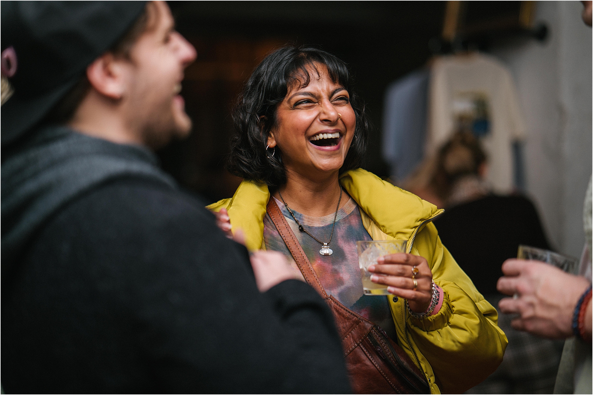A colour photograph of a guest laughing at a launch event. 