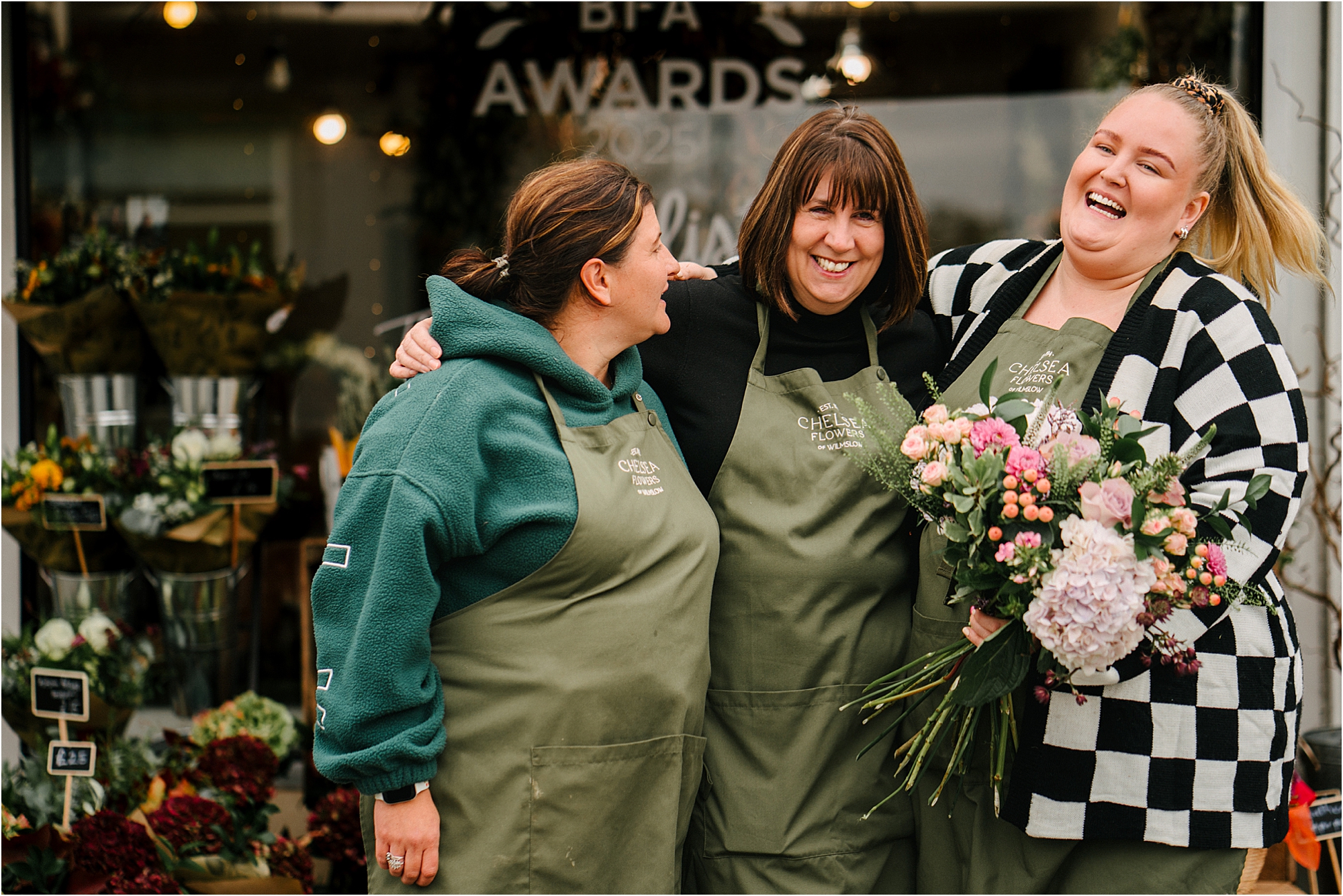 Coworkers laughing outside of their business. Photograph by Sheffield Photographer Kari Bellamy. 
